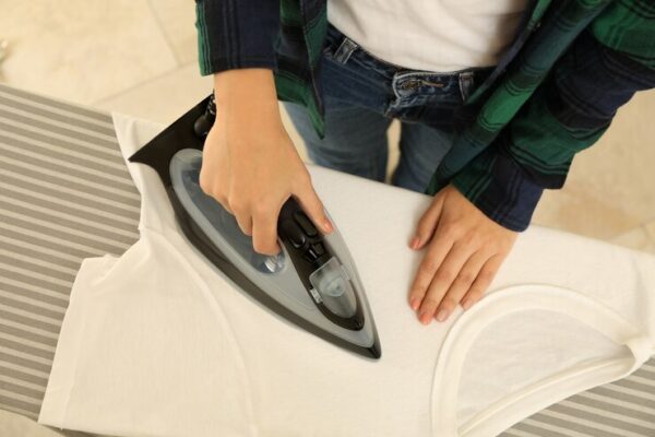 woman-jeans-ironing-t-shirt-with-iron_185193-26233